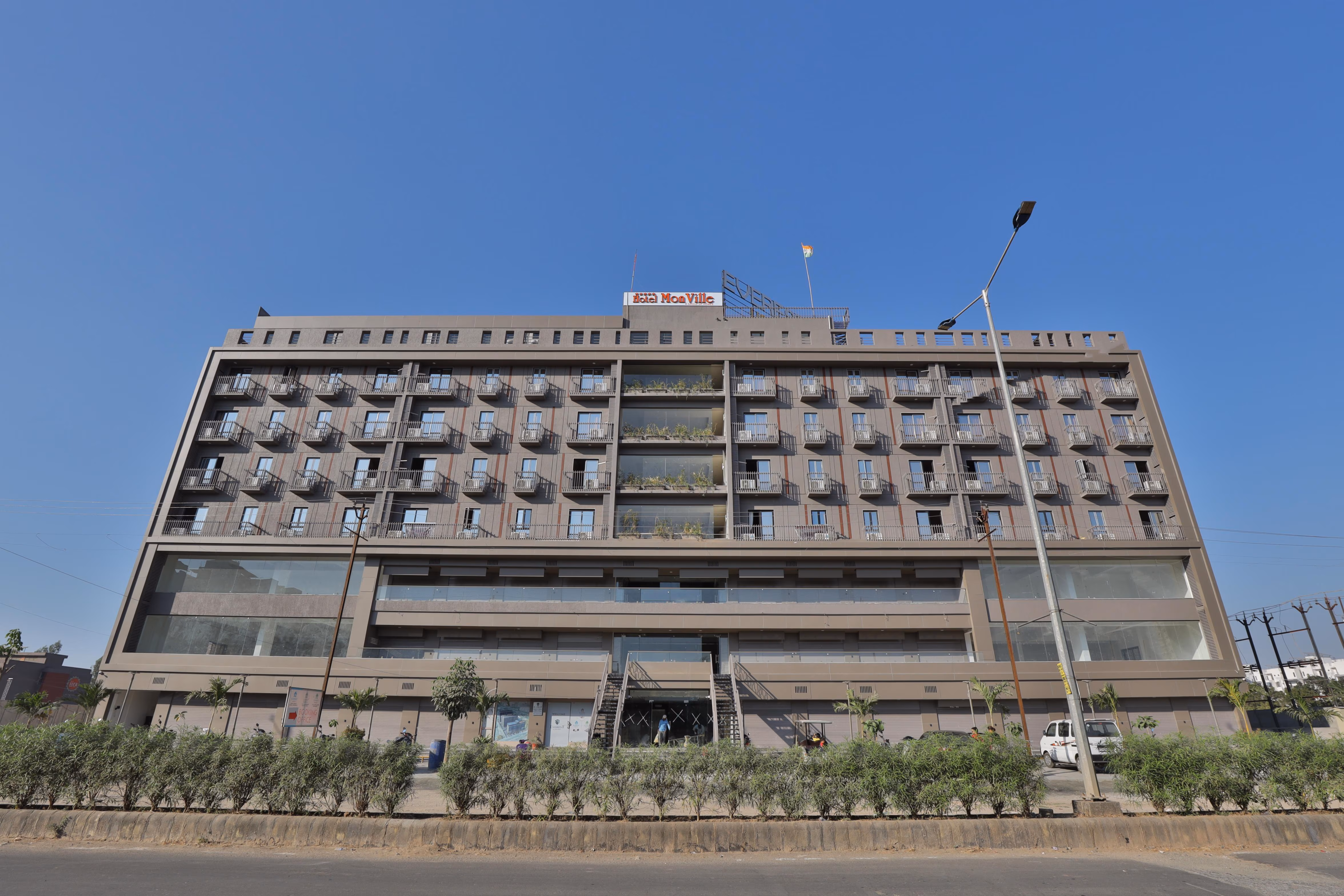 Hotel Monville building exterior with gardens